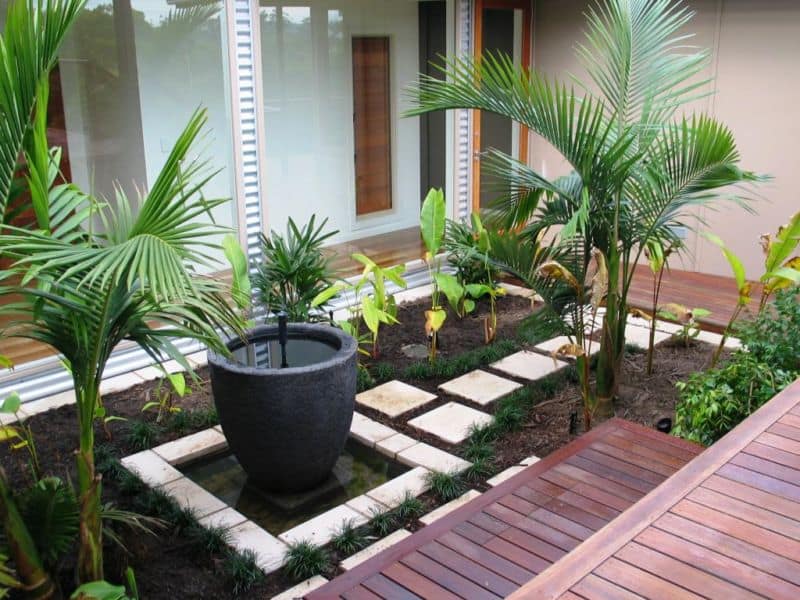 simple-garden-design-with-wooden-pattern-floor-and-green-foliages-idea
