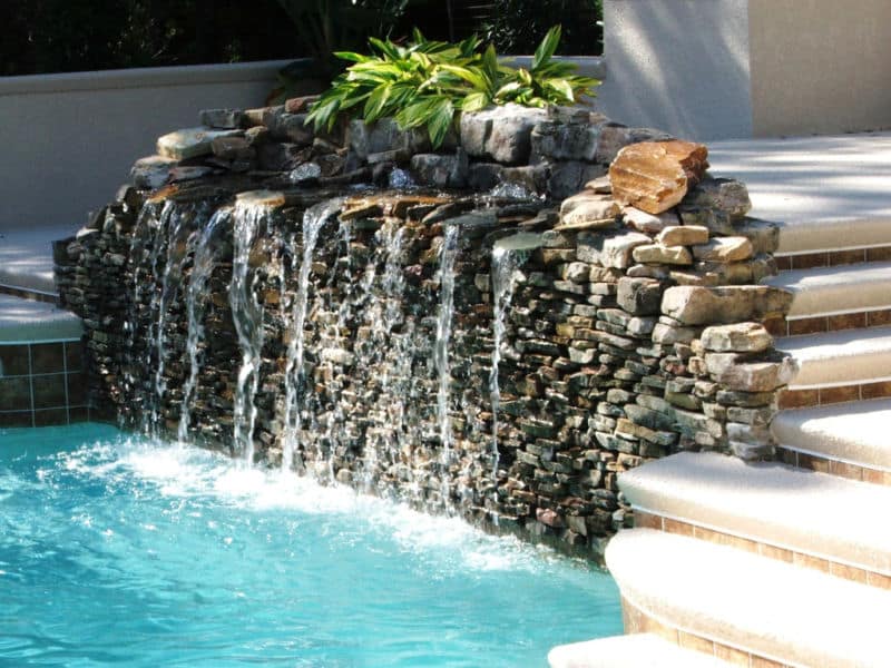 luxurious-exterior-house-idea-with-incredible-swimming-pool-decoration-again-ladder-made-of-concrete-material-also-water-fountain-design-plus-natural-stone-wall